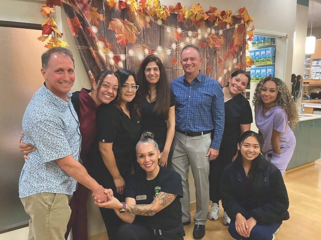 Dr. Eric Axelrode and Dr. Mark Axelrode with the Axelrode Orthodontics team. Indoor group photo.